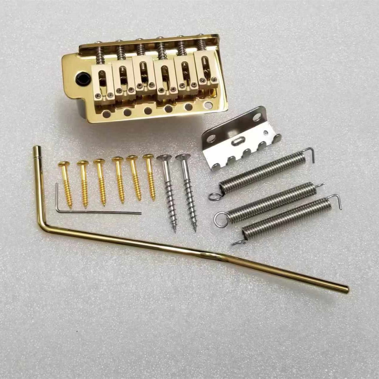 M1147-03 Tremolo Gold 6 Point Style Fixed Bridge. 52.5mm String Spacing
