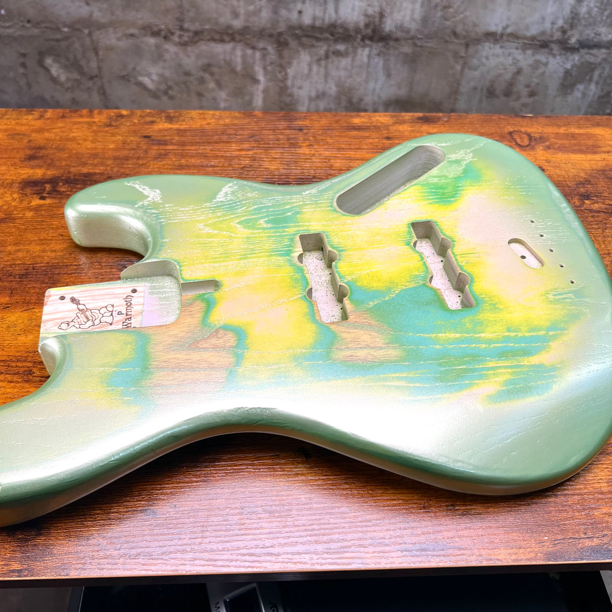 Green and yellow custom painted bass body with pickup and neck screw routes