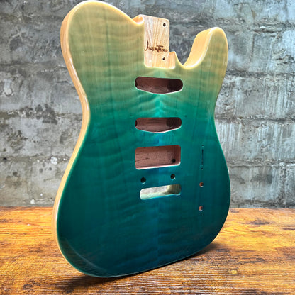 Teal glossy Tele-style guitar body back with routed cavities and mounting screw holes