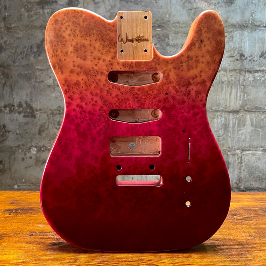 Cherry-red berry burl guitar body rear with routed channels, control openings, and screws