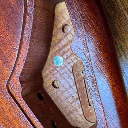 Strat-style guitar body top with pickguard area and screw holes; flamed maple in amber