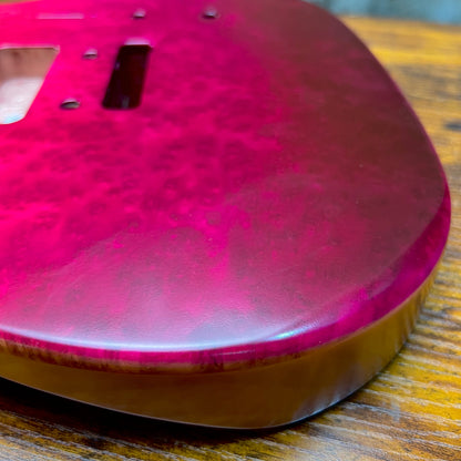 Berry burl guitar body top close-up with glossy finish and pickup mounting area