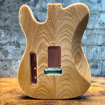 Natural flamed maple Tele-style guitar body back with strap button and mounting holes