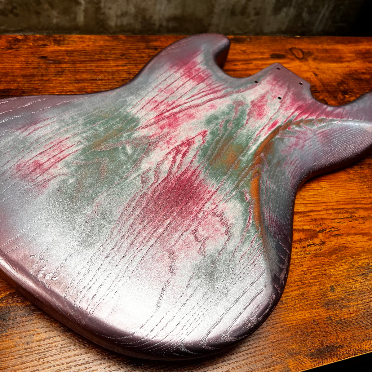 Replacement J Bass body, silvery pink-and-green nitro relic finish, side contours visible