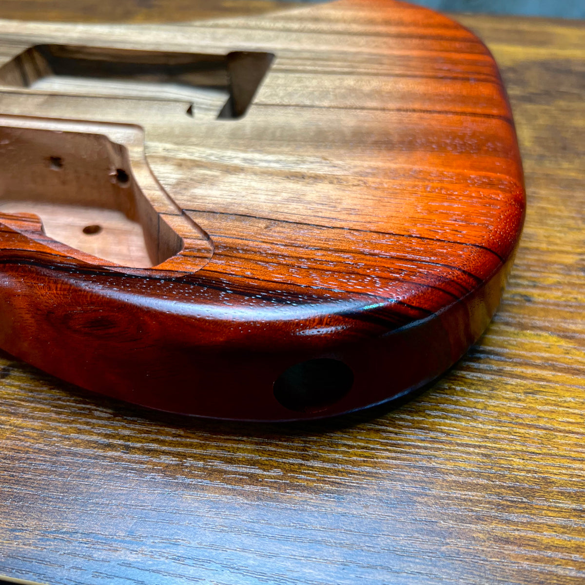 Strat-style guitar body back end with bridge mounting hole and curved contour