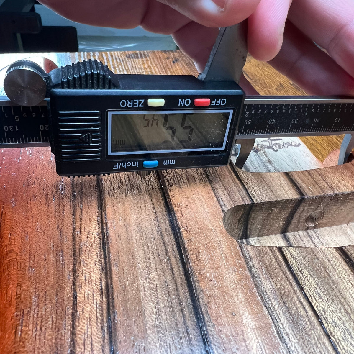 Strat-style guitar body with control cavity and measurement ruler laid across