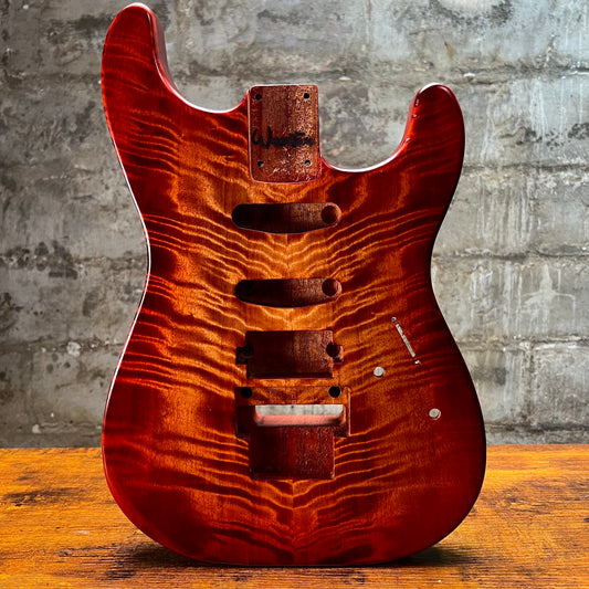 Flamed maple Strat-style guitar body front view with control and pickup cavities