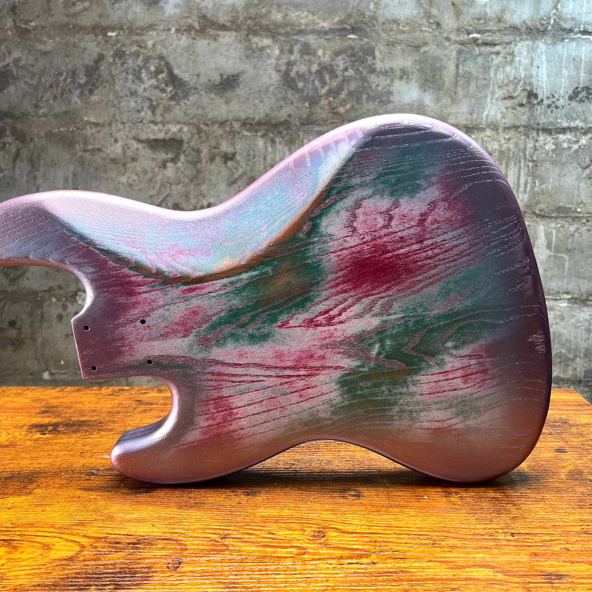Replacement J Bass body side profile with pink and green relic finish on roasted swamp ash