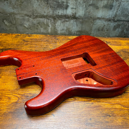 Flamed maple Strat-style guitar body angled view with neck pocket and cutouts