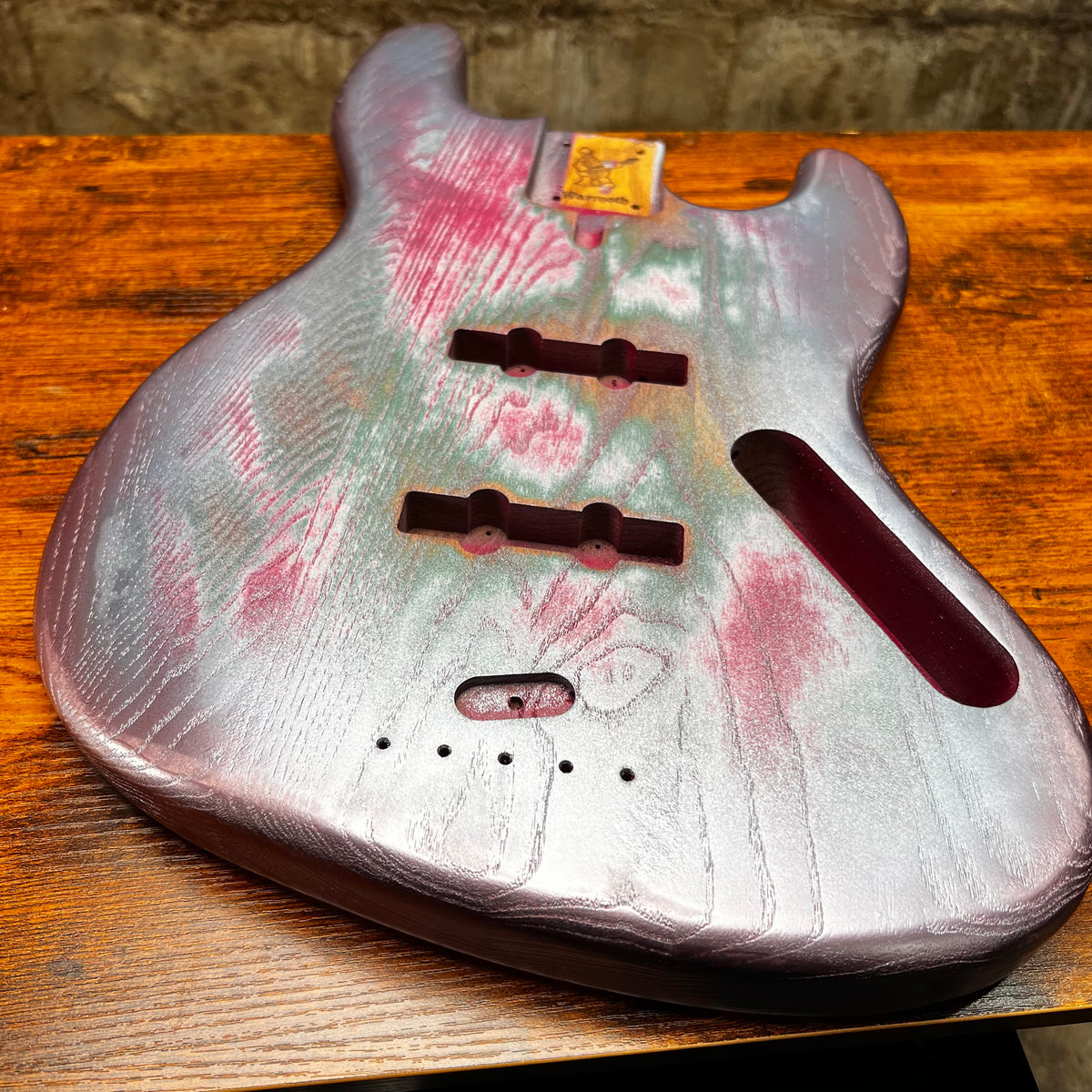 Replacement J Bass body, silvery with pink and green relic finish, front routing and holes