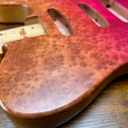 Berry burl guitar body contour with pickup rout and screw holes visible