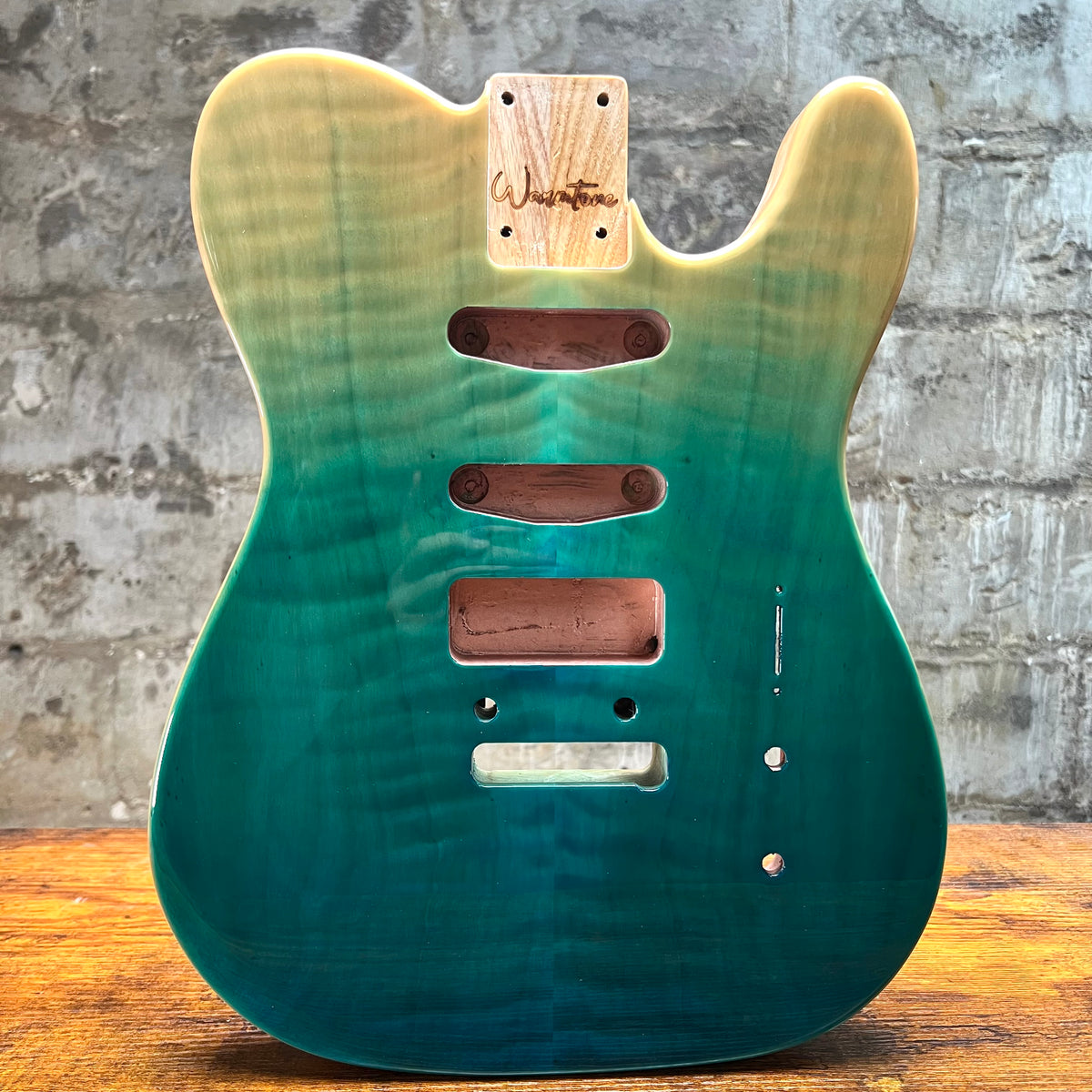 Teal glossy Tele-style guitar body back with control cavity routes and mounting holes