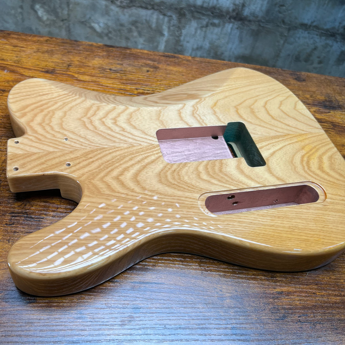 Natural flamed maple Tele-style guitar body with P90 routes and glossy finish