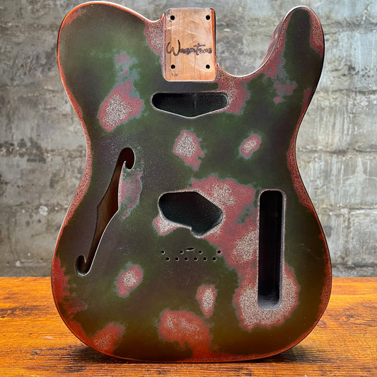 Telecaster-style guitar body with orange binding, green relic finish and cutout controls