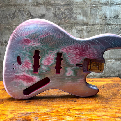 Replacement J Bass body, silvery multicolor relic finish, front view with neck pocket and routs