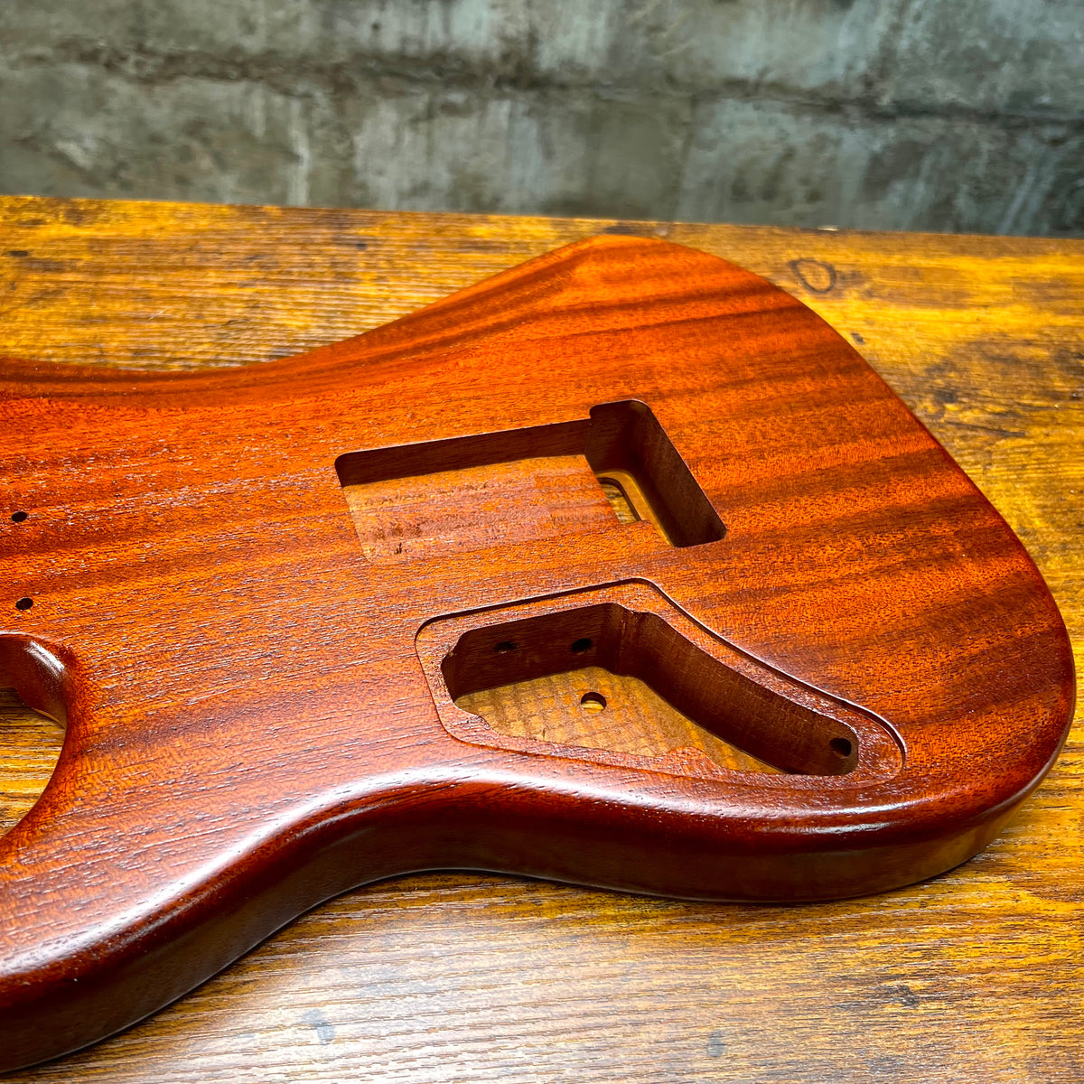 Vintage amber Strat-style guitar body with neck pocket and pickup/controls cutouts