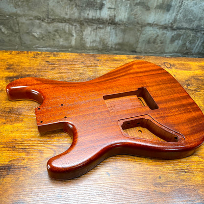 Strat-style guitar body front view in vintage amber flamed maple with large control rout
