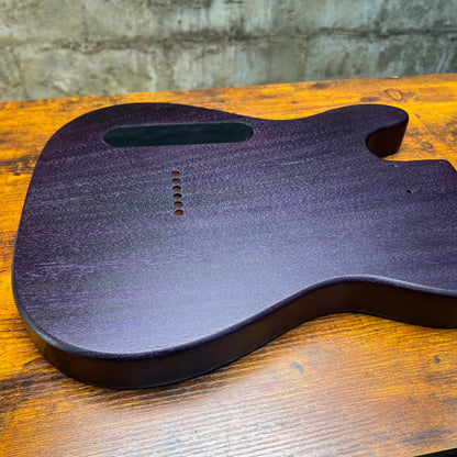 Telecaster-style guitar body back in purple-blue finish with route openings and screw holes