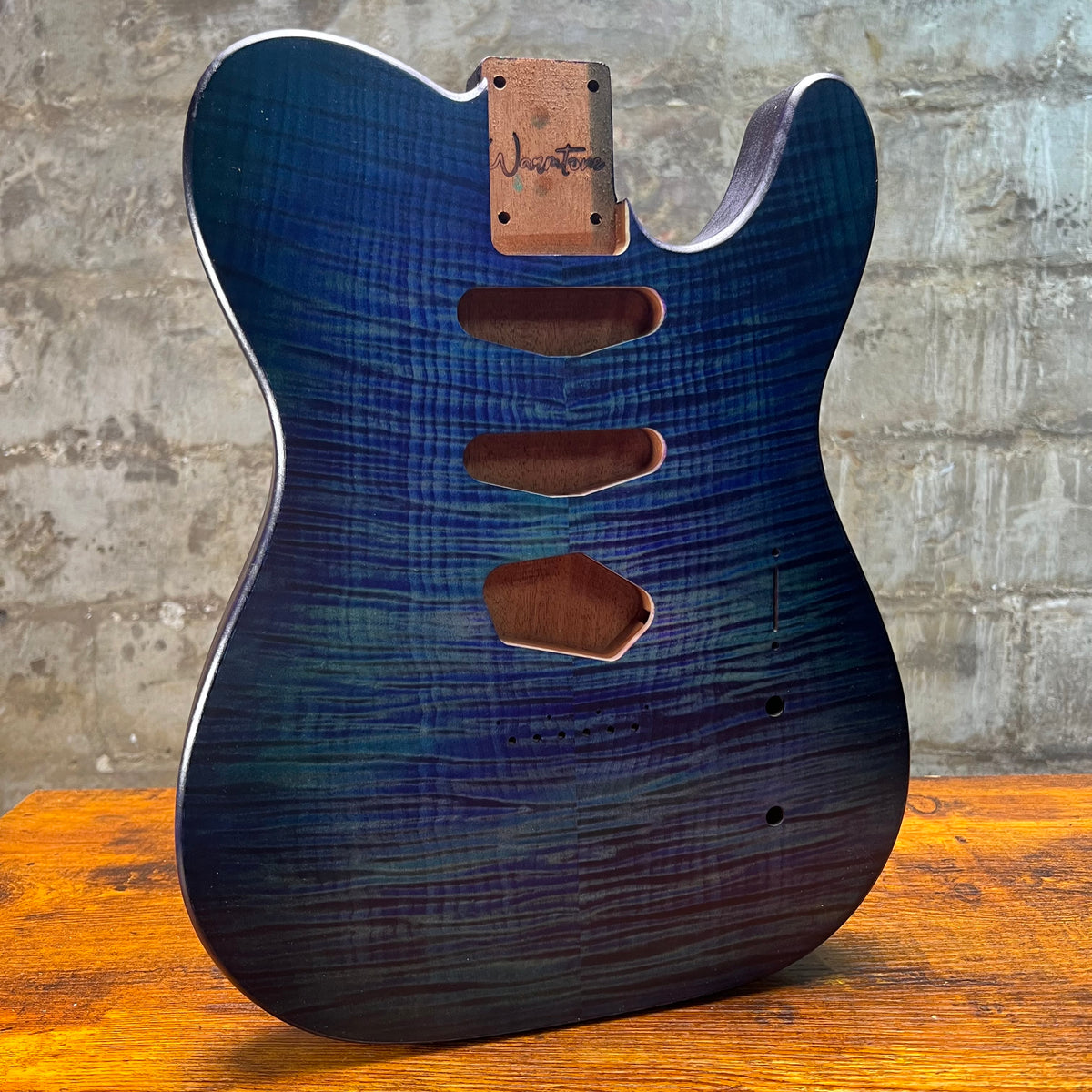 Telecaster-style guitar body in blue flamed maple with neck plate and pickup routes